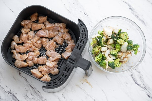 Chicken in air fryer, broccoli and onion on the side