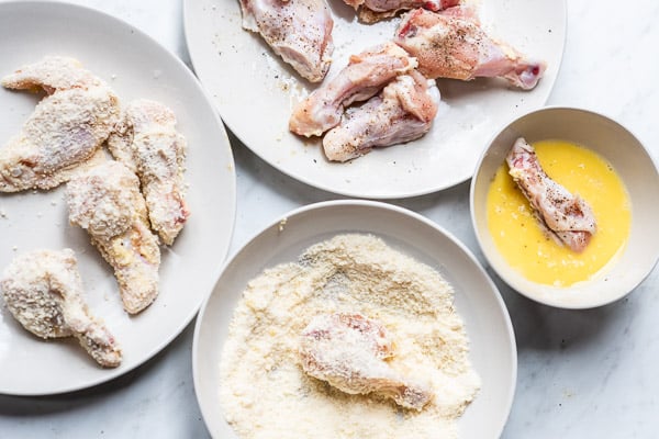 Coating chicken wings in egg and parmesan
