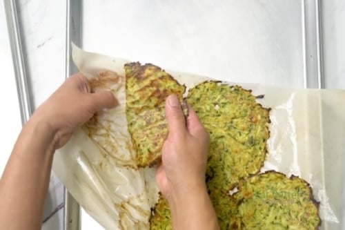 Peeling zucchini tortillas off parchment